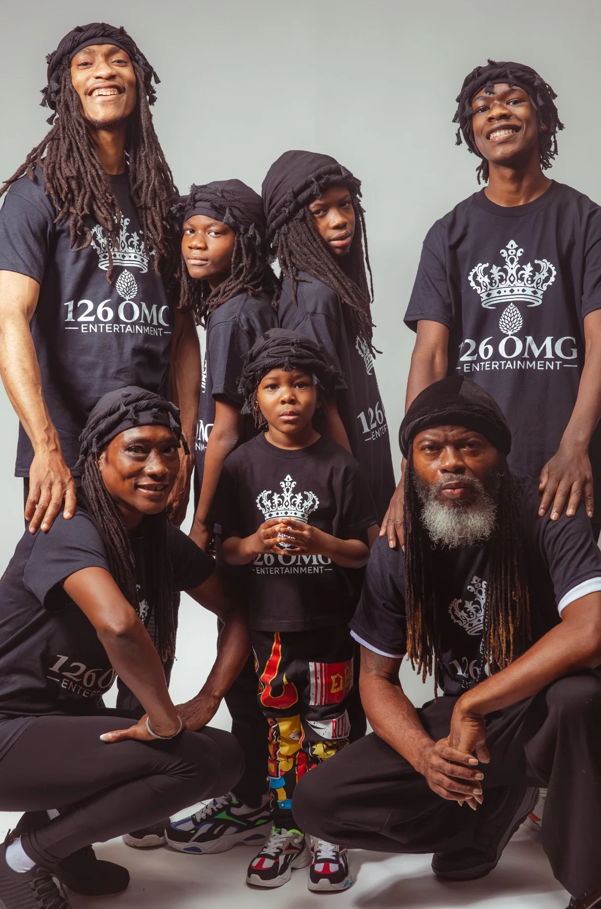 CITYSLIC THE OG and ELA OMG with five of his sons in 126 OMG Entertainment shirts