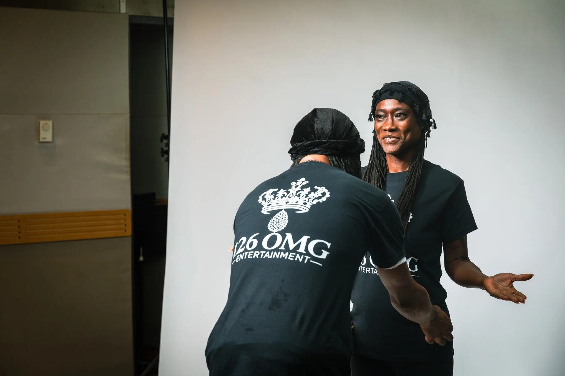 CITYSLIC THE OG adjusting ELA OMG’s shirt during the family photo session